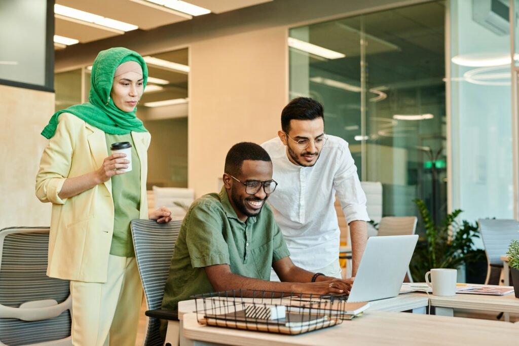 Image of employees looking at a laptop screen