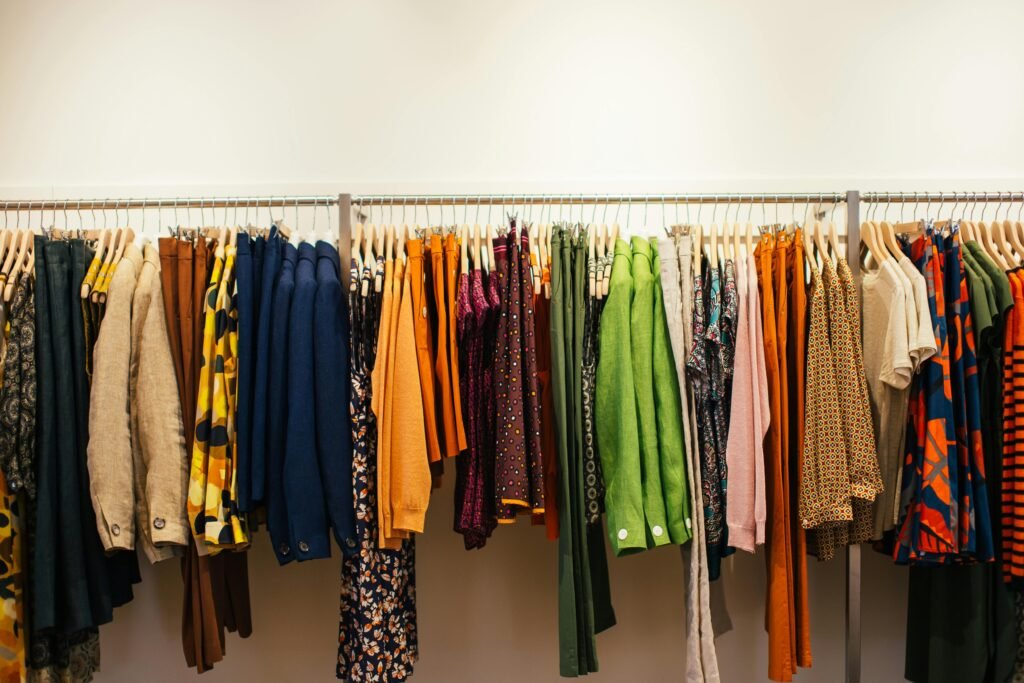 Image of Multicolored clothes hanging on rack