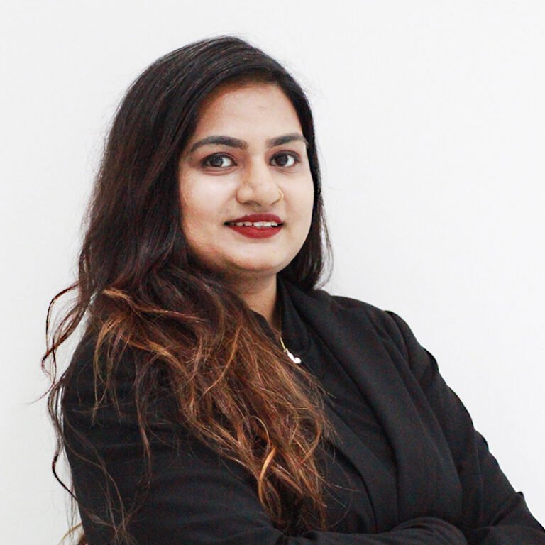 Portrait of a team member in a dark blazer against a white background